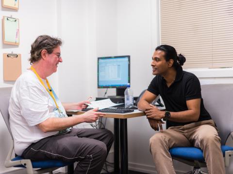 ASRC staff member in meeting with man who is seeking asylum